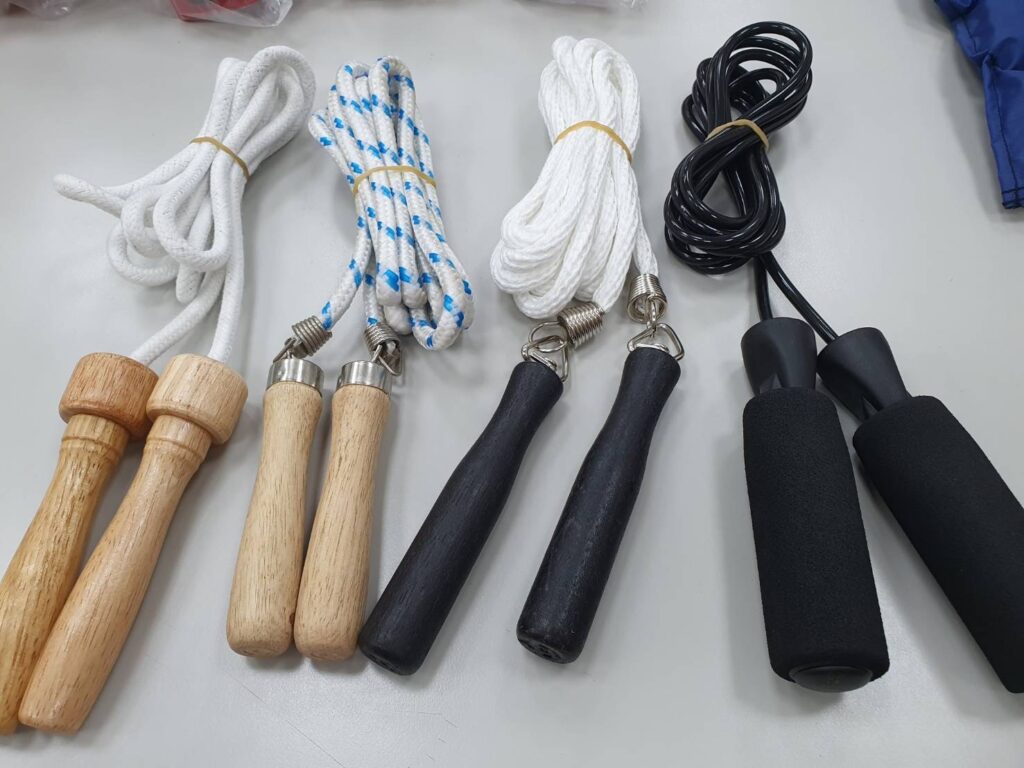 Four jump ropes with wooden, black and foam handles