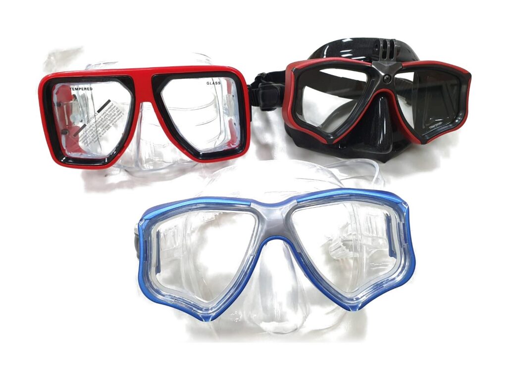 Three diving masks in red, black and blue