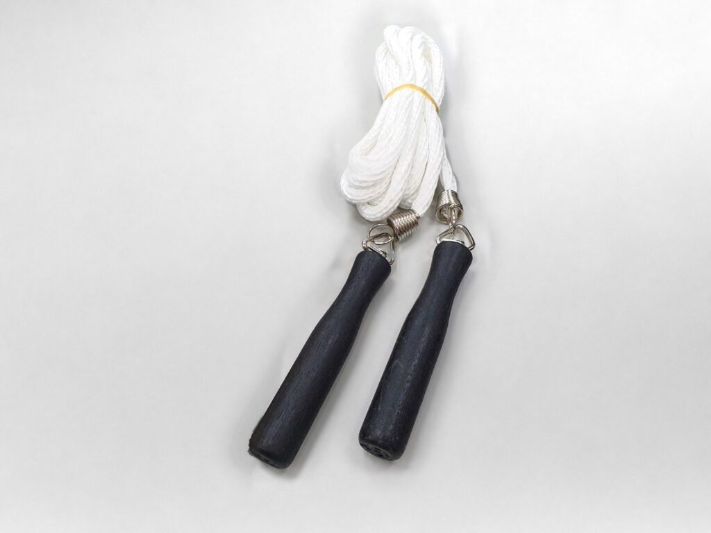 Jump rope with a white rope and black handles