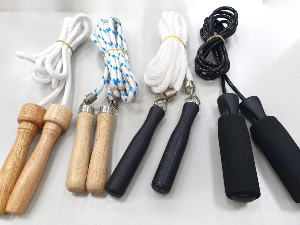 Four jump ropes with wooden, black and foam handles